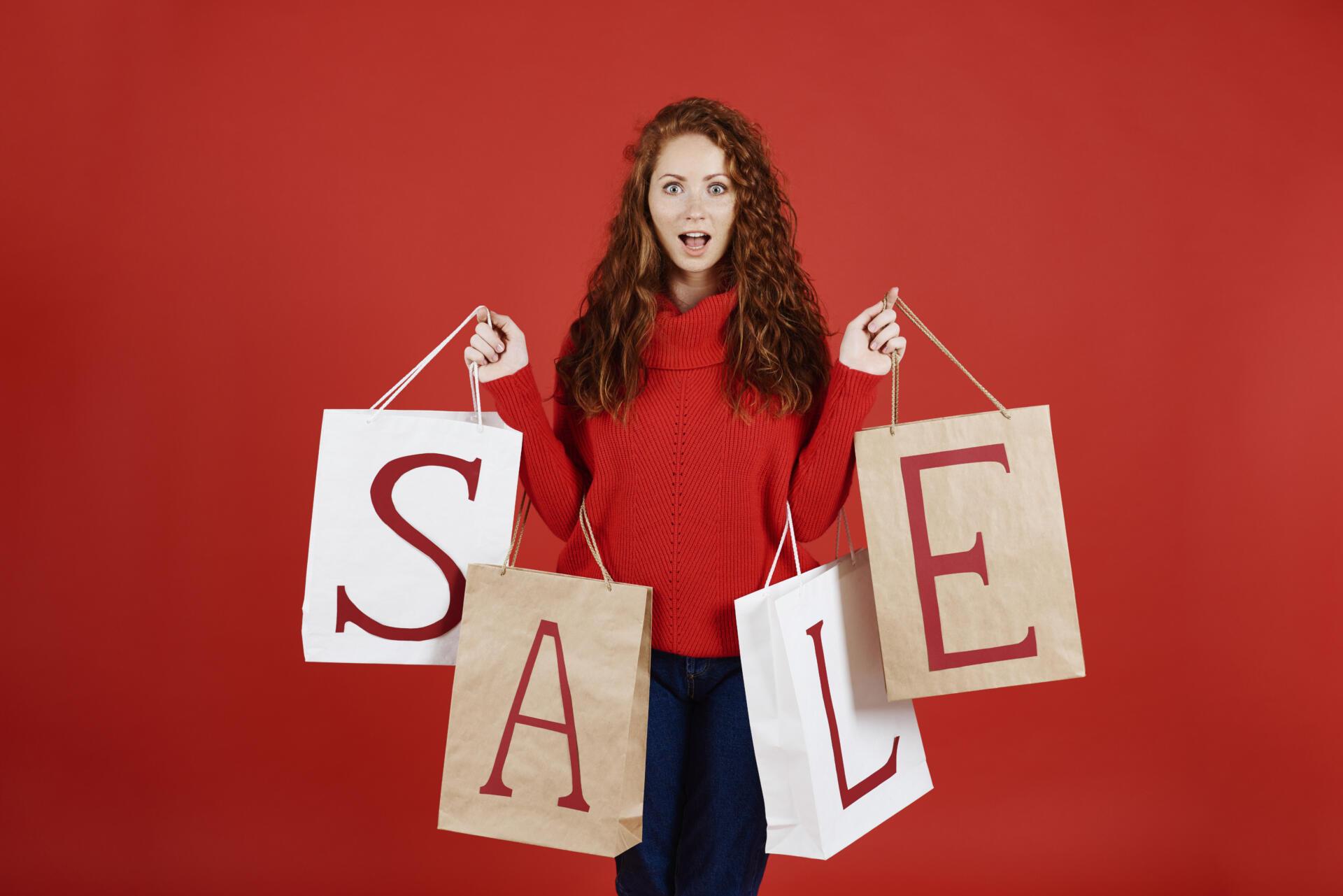 screaming girl with shopping bags studio shot